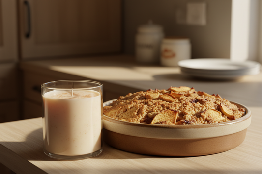 a apple strudel scented candle without a label and an apple cobbler next to in, with a subtle kitchen background